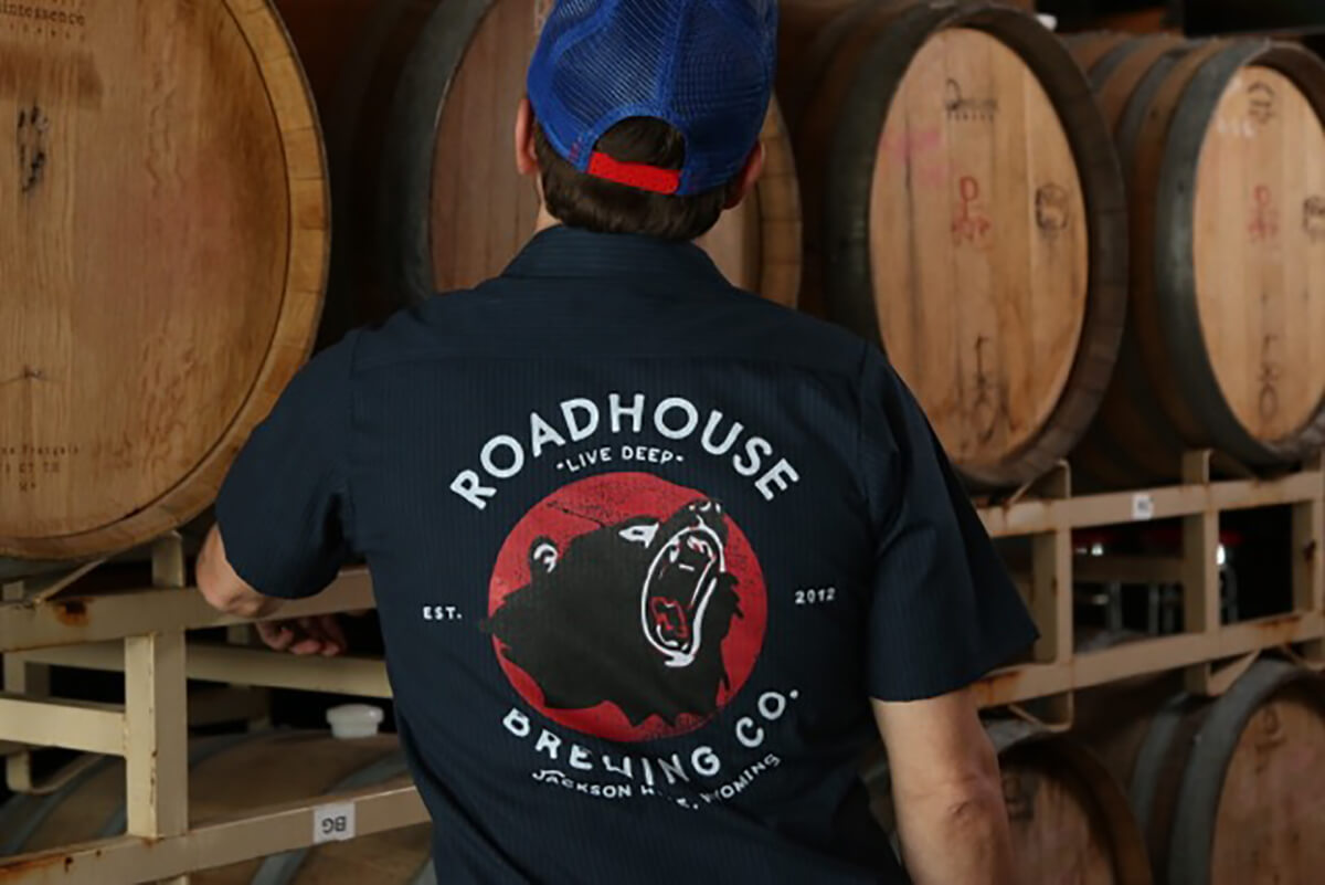 Man standing in front of Barrels